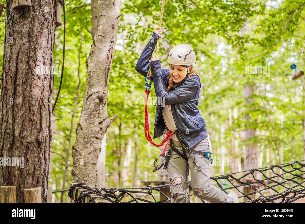 Happy women girl female gliding climbing in extreme road trolley