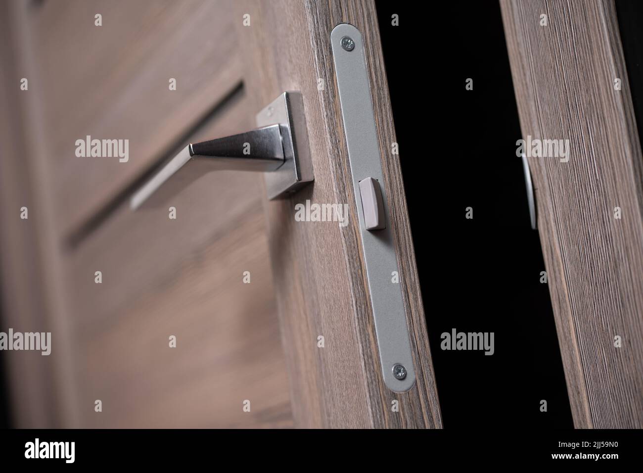 modern and secured metal door handle and latch detail Stock Photo Alamy