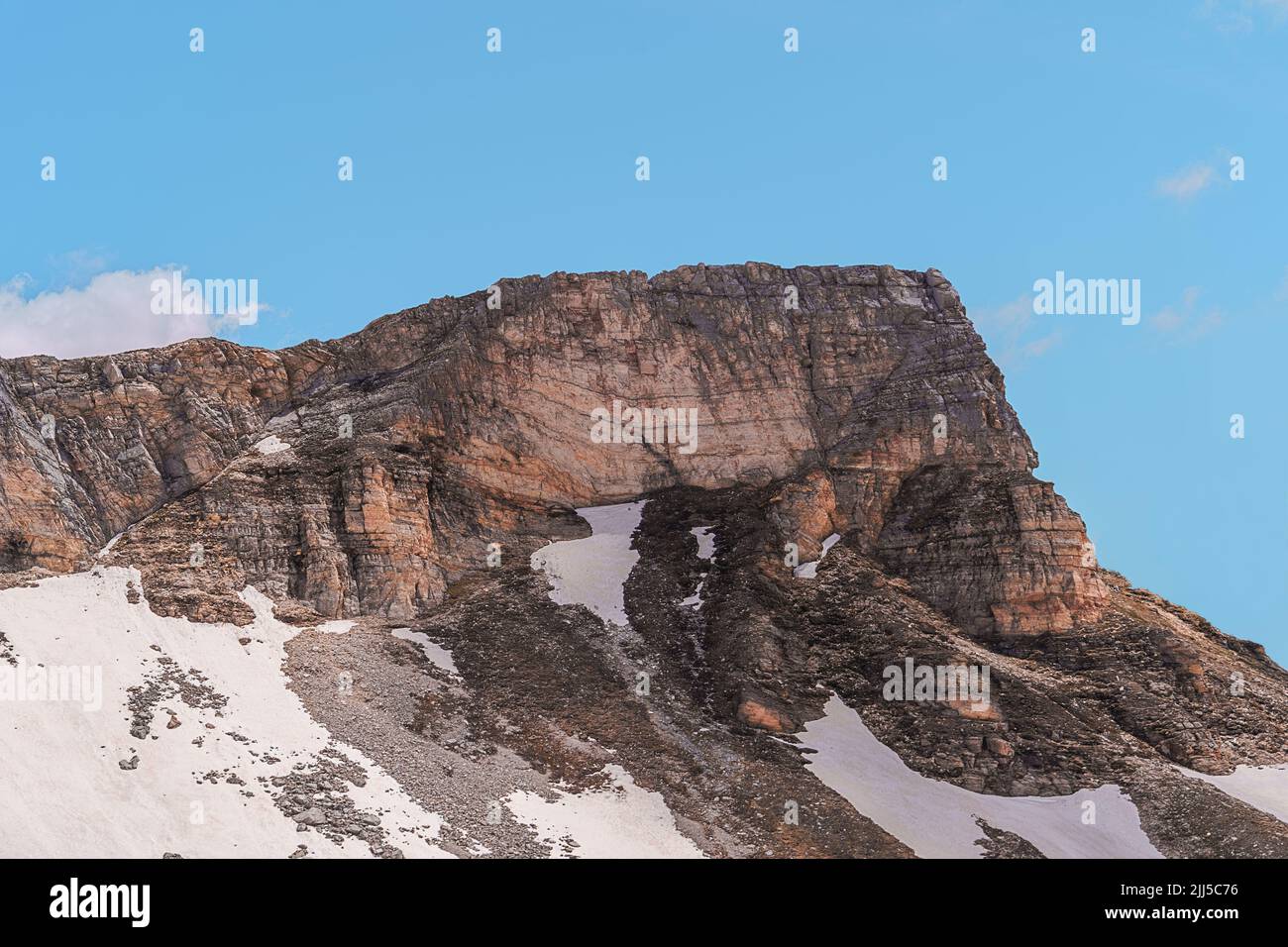 Top of a mountain, big rock, in the alps against blue sky Stock Photo