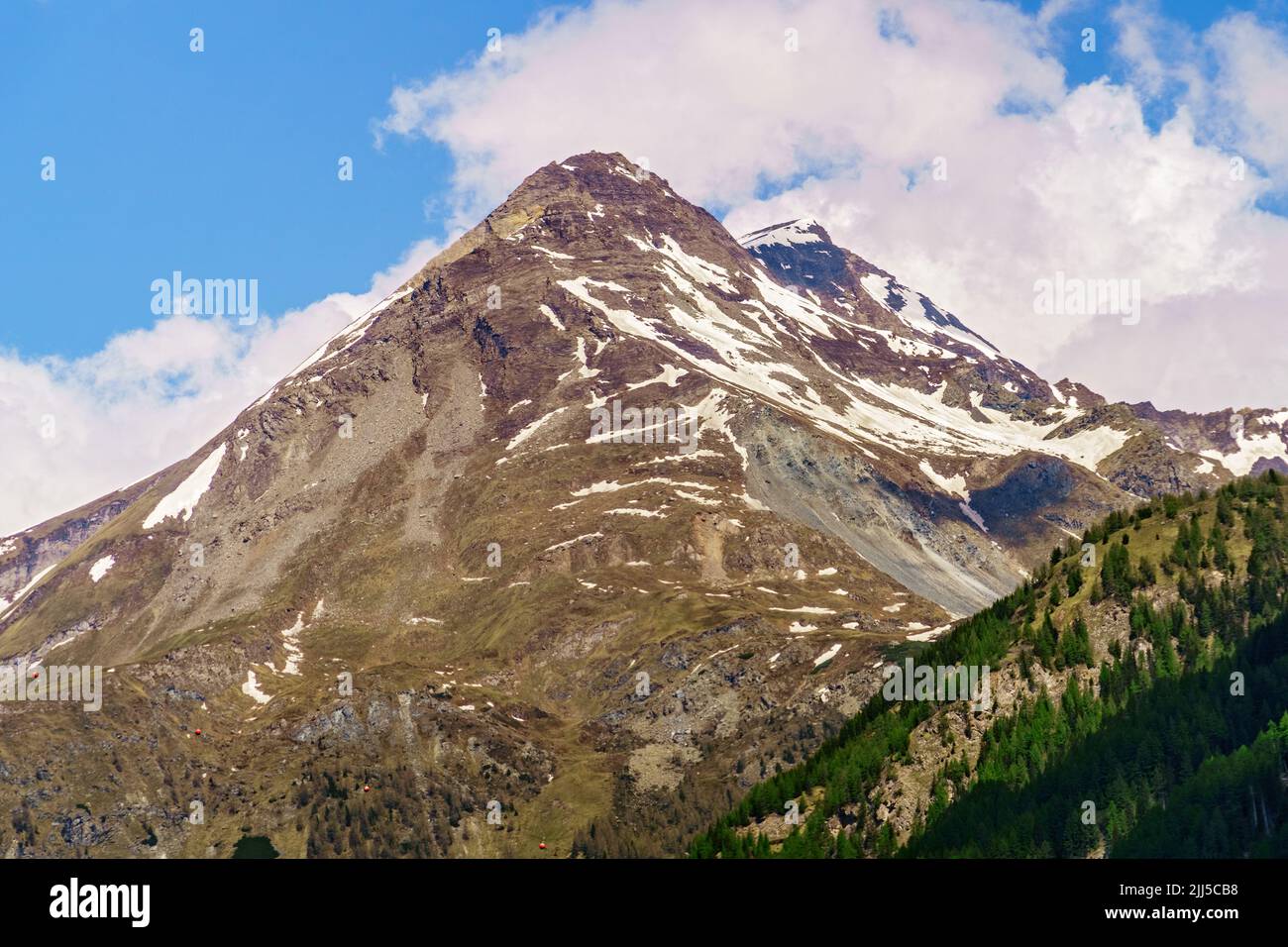 High mountain in the alps, Austria, partly covered with snow, with a rockfall. Stock Photo