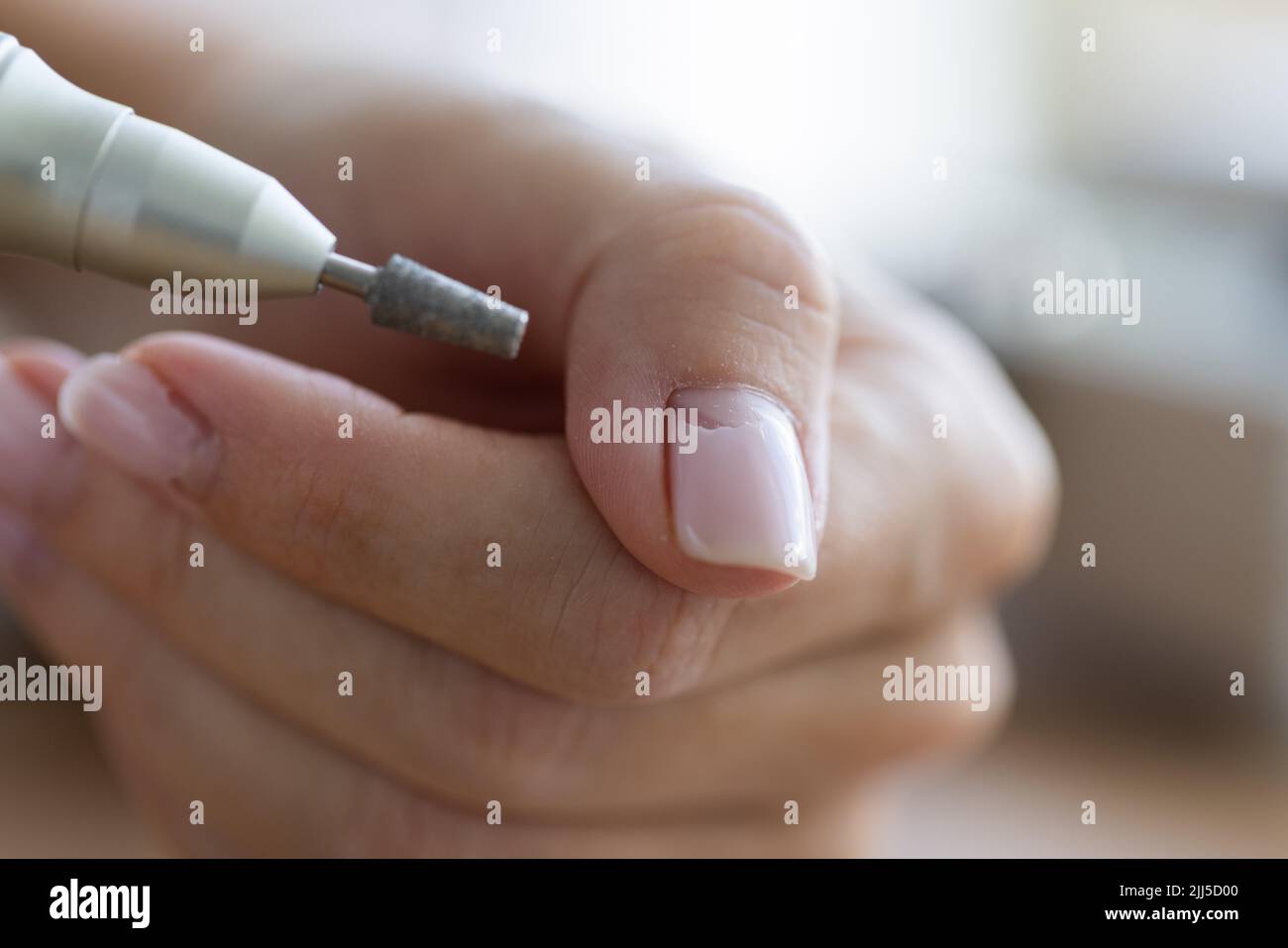 Removing shellac from the nails with fraser. Closeup. Selective focus