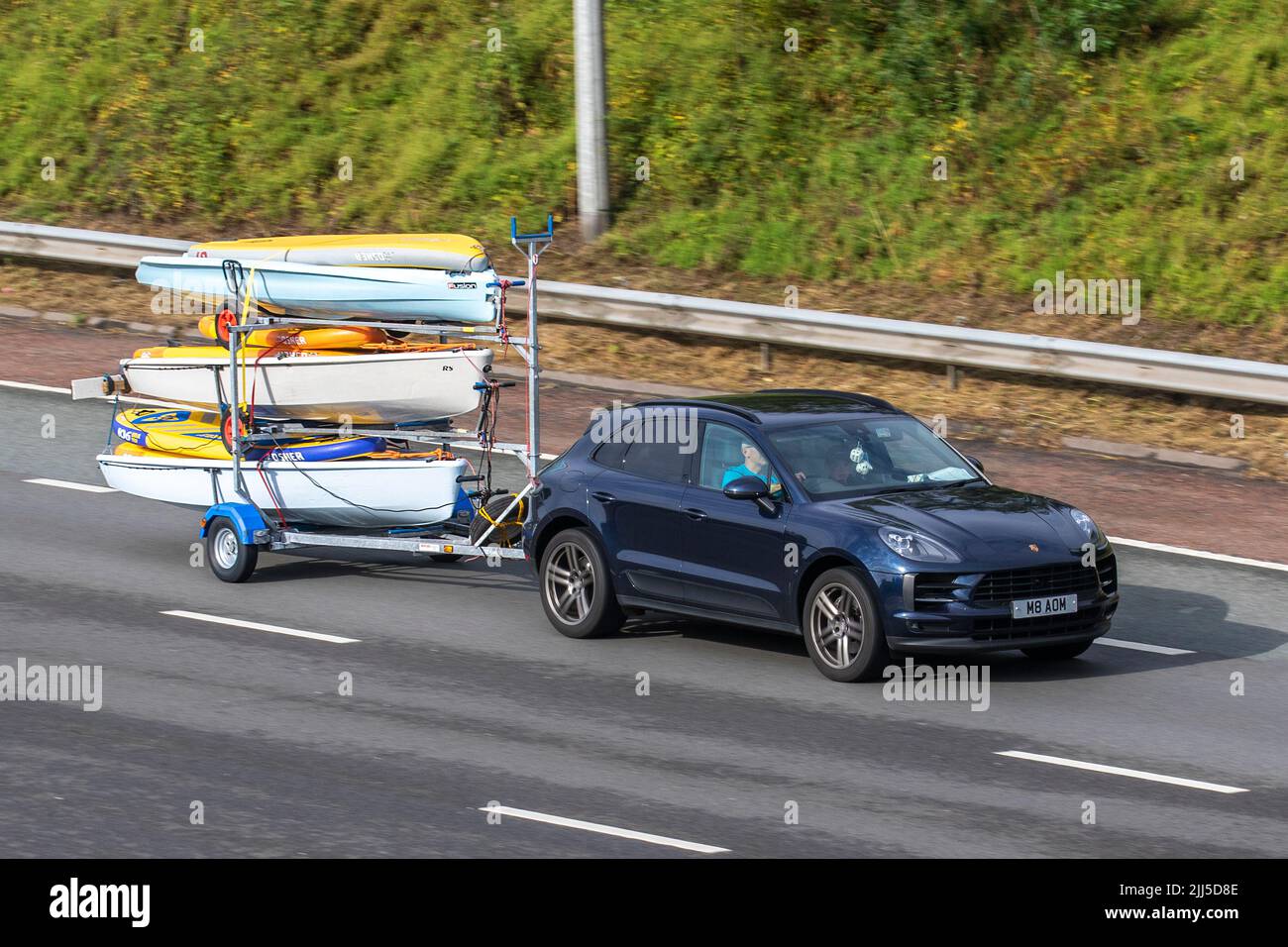 2019 PORSCHE MACAN S PDK 2995cc 7-speed semi-automatic towing Kayak, water sports canoe trailer; traveling on the M6 motorway, UK Stock Photo