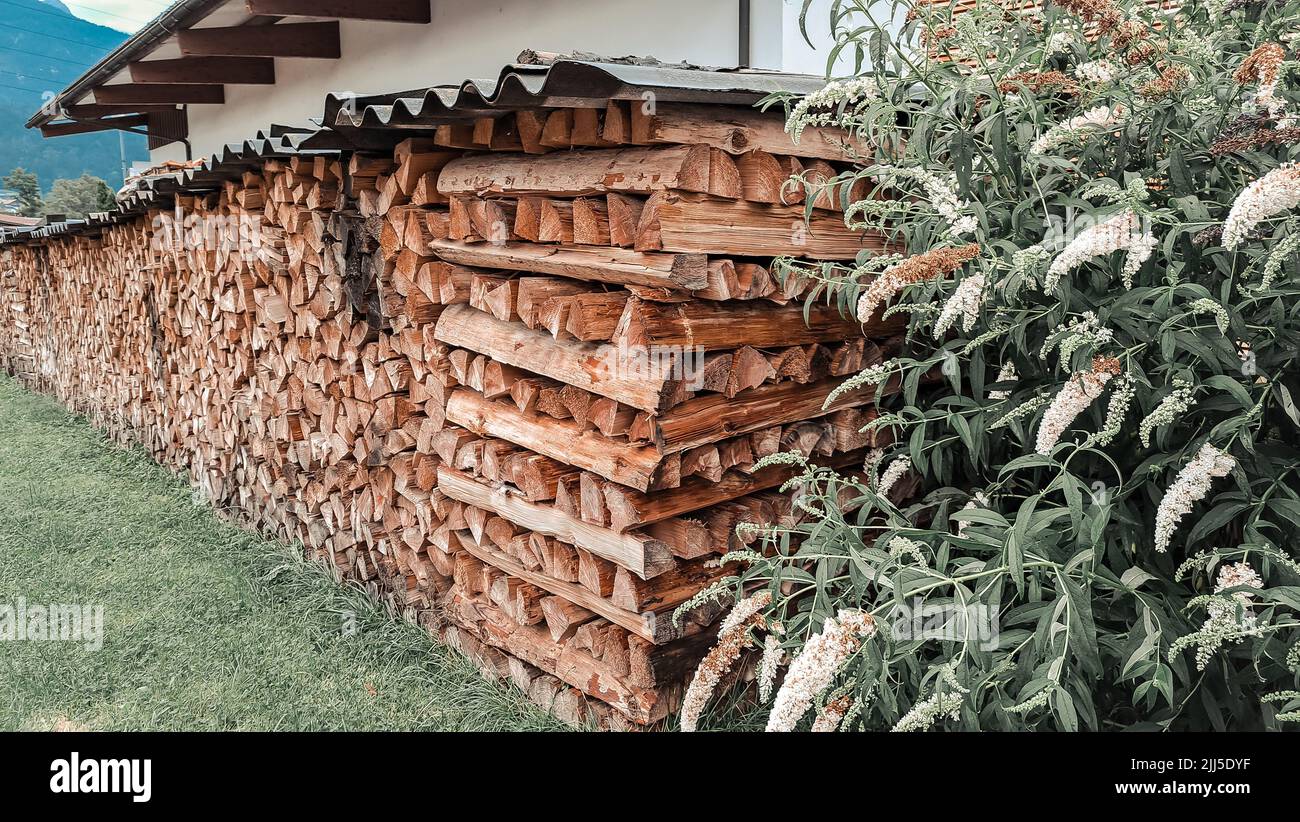 Big storage of wooden bricks in the village in mountains. High quality photo Stock Photo