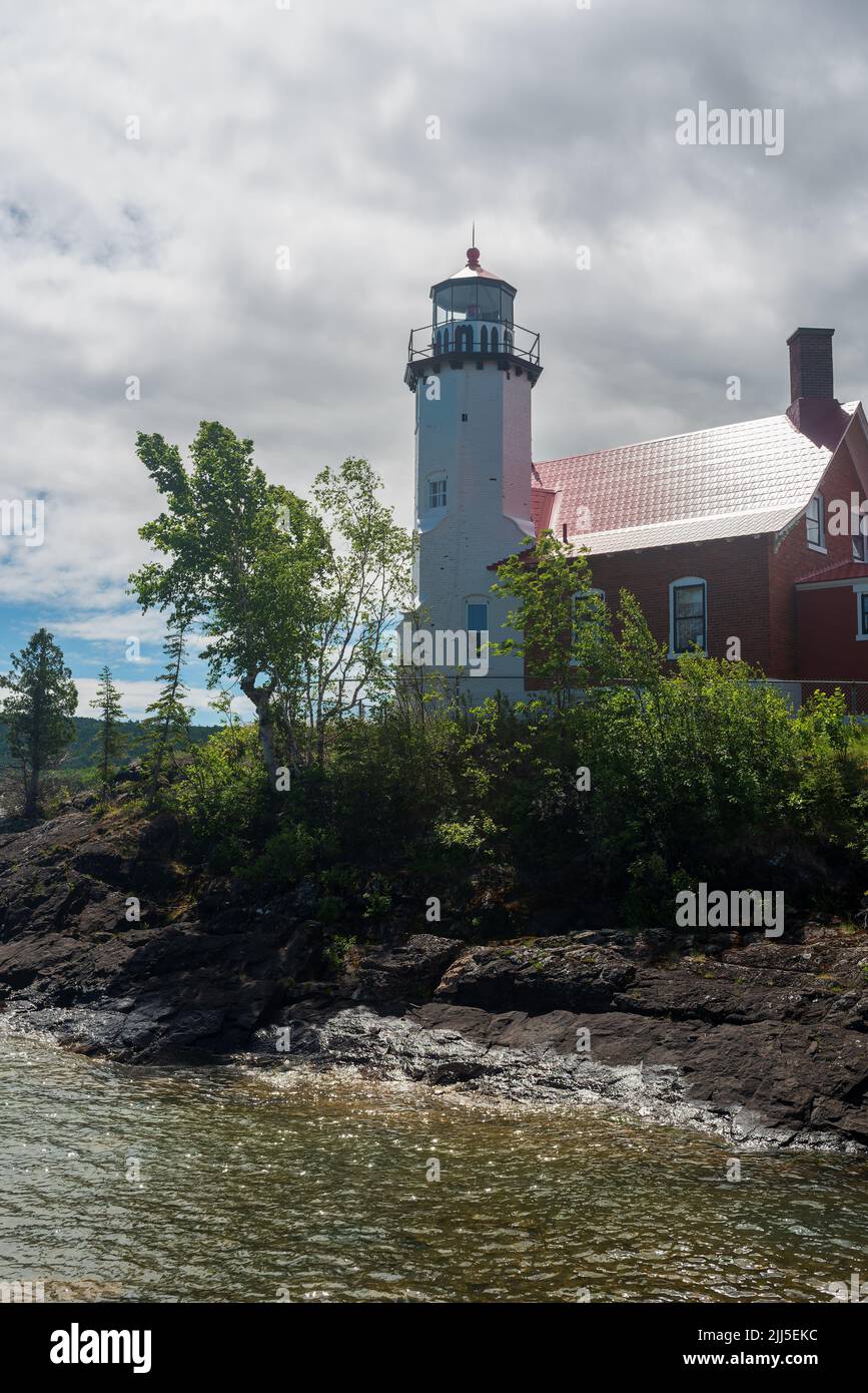 Eagle Harbor Lighthouse stands above a rocky entrance to Eagle Harbor