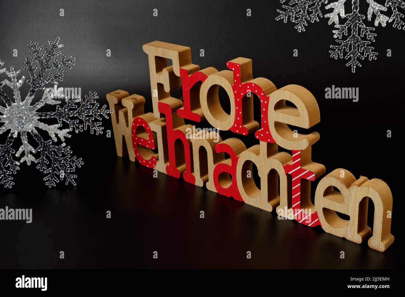 Christmas decoration with german text  frohe weihnachten and snow flakes Stock Photo