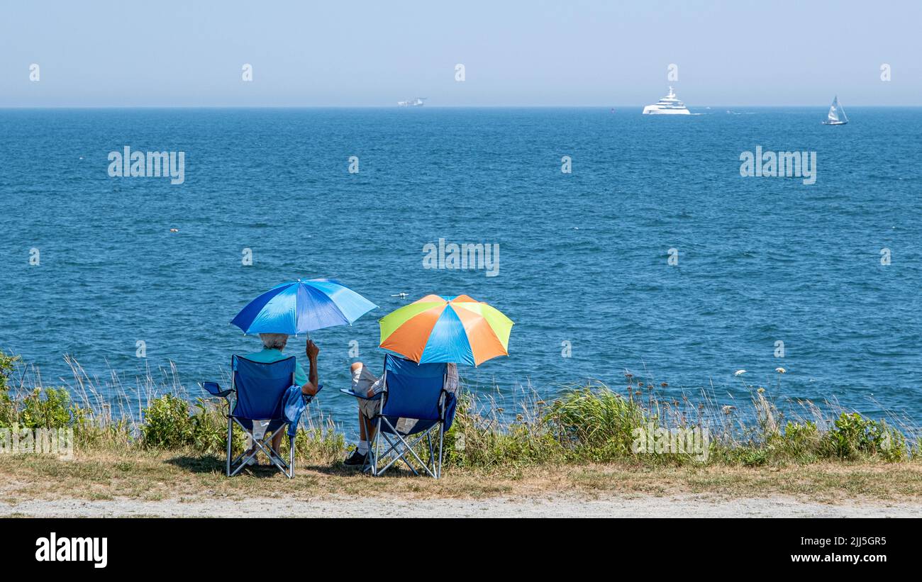 Couple sitting at the oceans edge in Beaver Tail State Park in Jamestown, Rhode Island Stock Photo