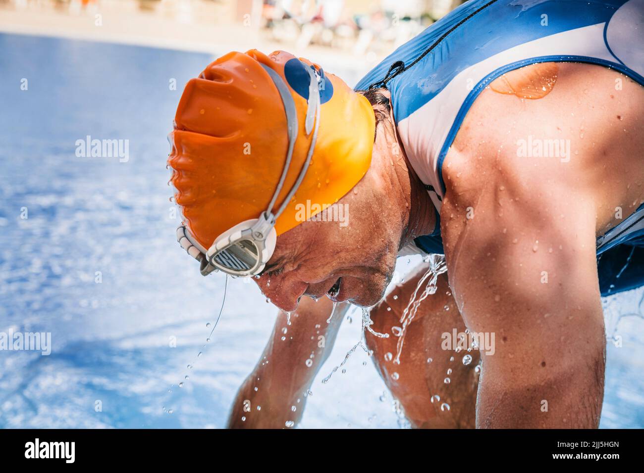 Spain, Mallorca, Sa Coma, triathlet swimmer getting out of pool Stock Photo