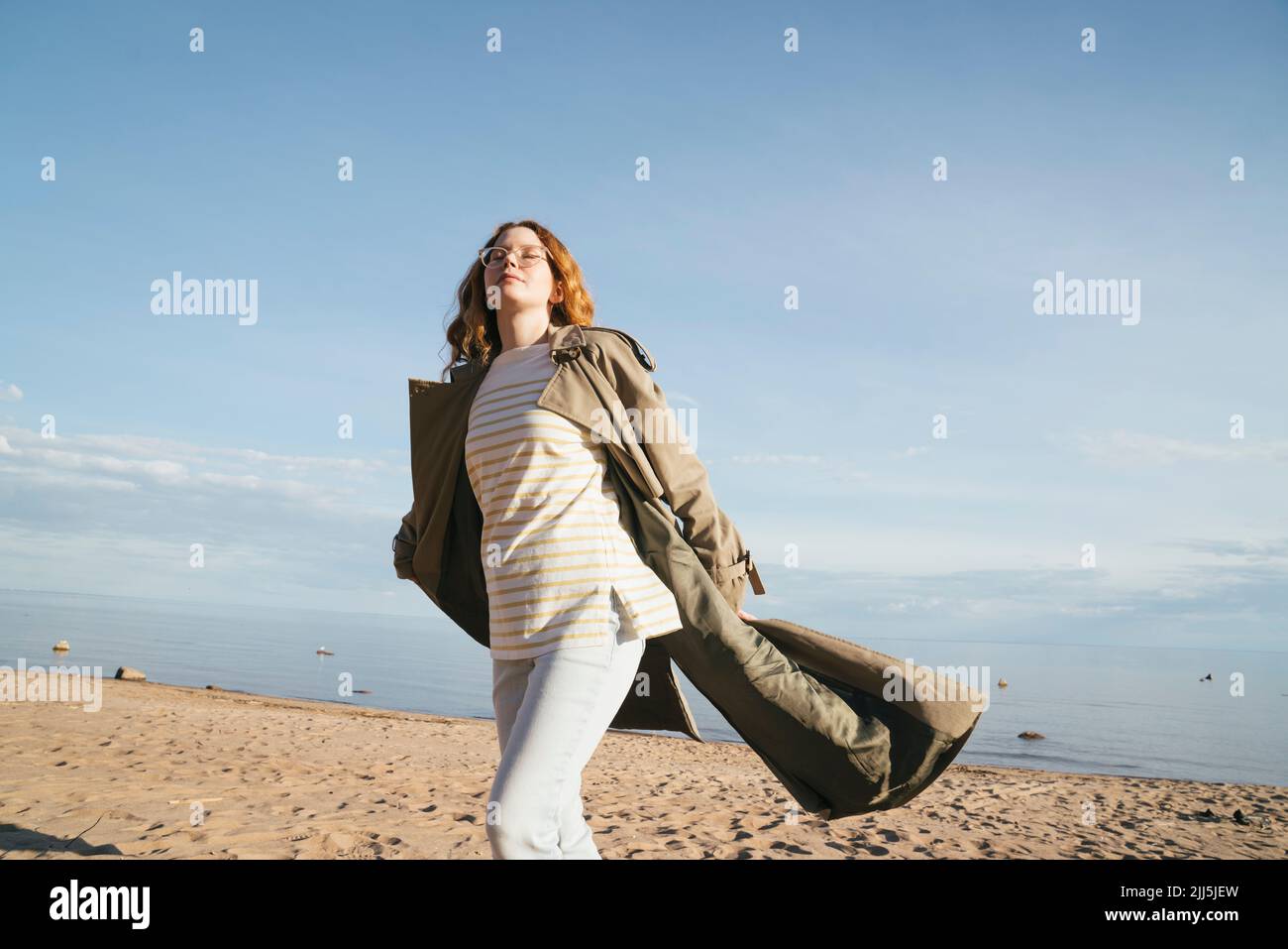 Young woman with eyes closed dancing at beach Stock Photo Alamy