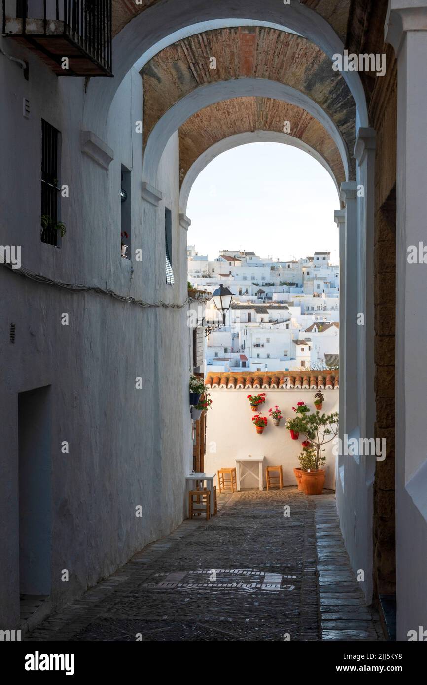 Spain, Province of Cadiz, Vejer de la Frontera, Arched walkway with houses in background Stock Photo