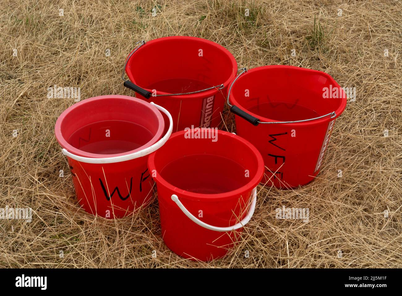 Fire buckets with water, on dry grass, at the Warwick Folk Festival