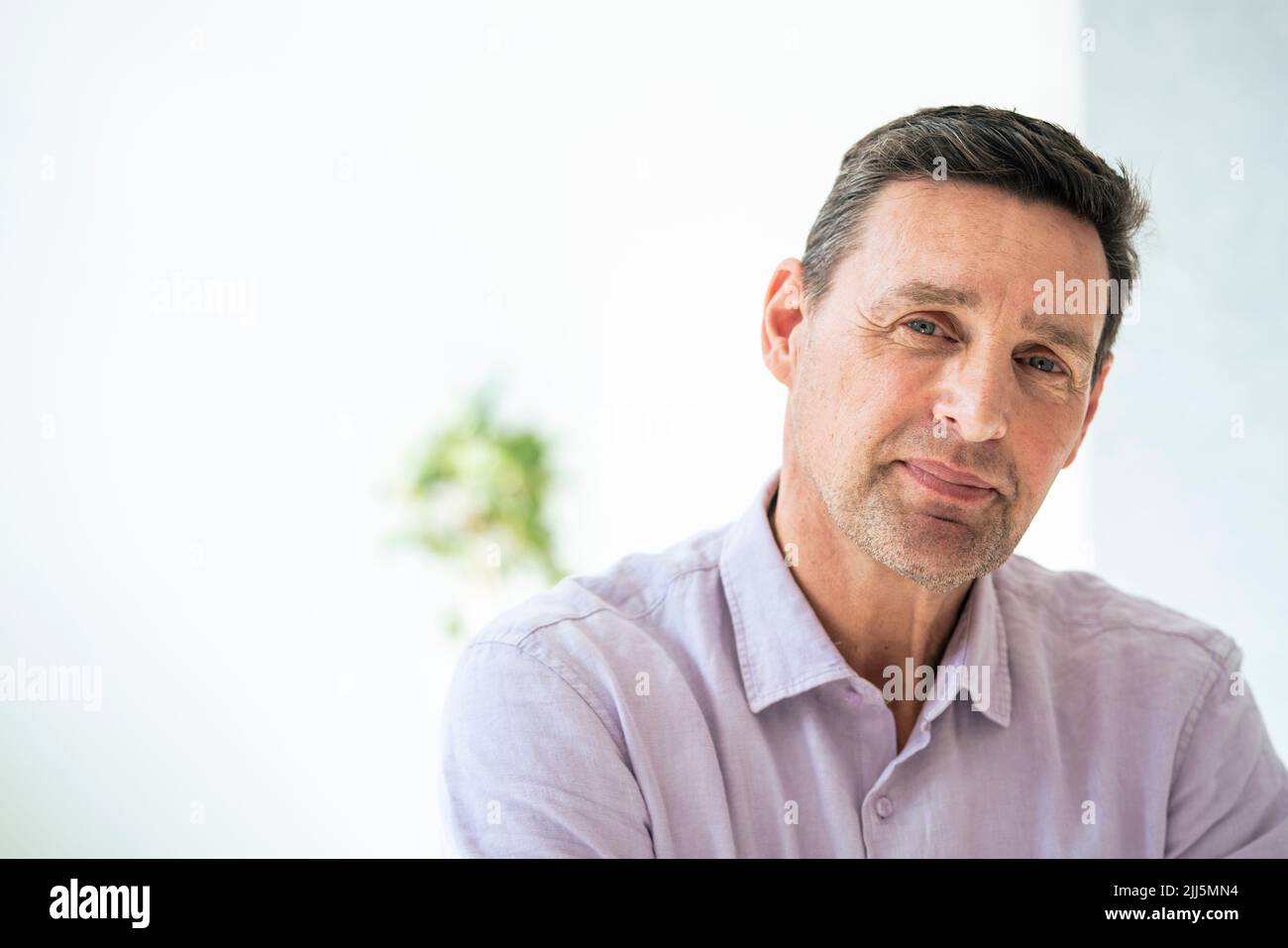 Mature businessman smiling at office Stock Photo