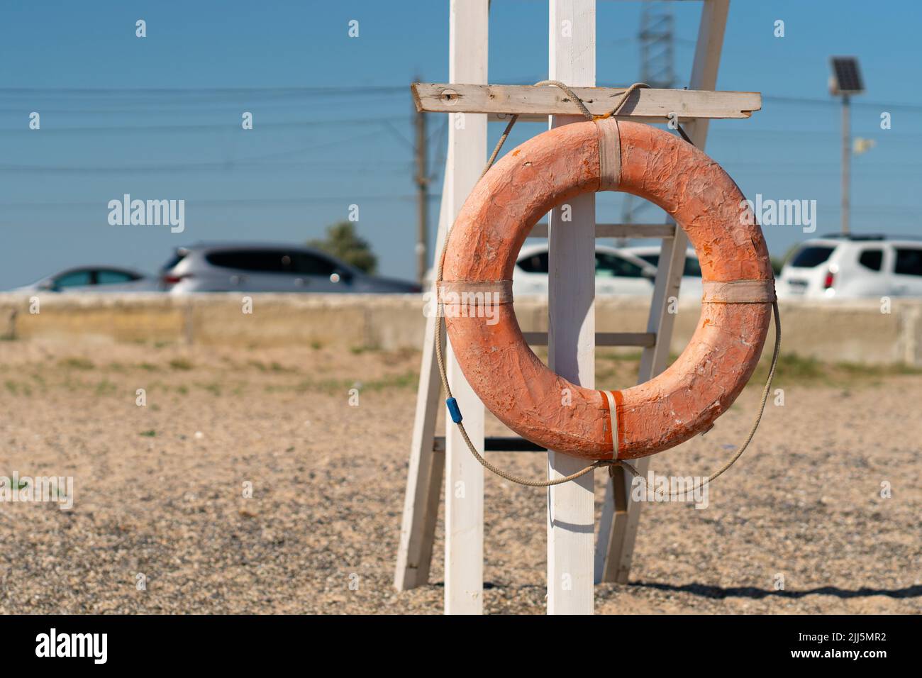 Old Crimea beach saver life preserver protection equipment red sea, for rescue save from belt from sky summer, object background. Travel sunrise round Stock Photo