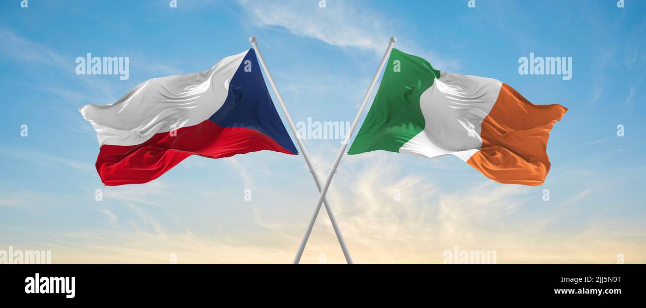 two crossed flags Ireland and Czech republic waving in wind at cloudy ...