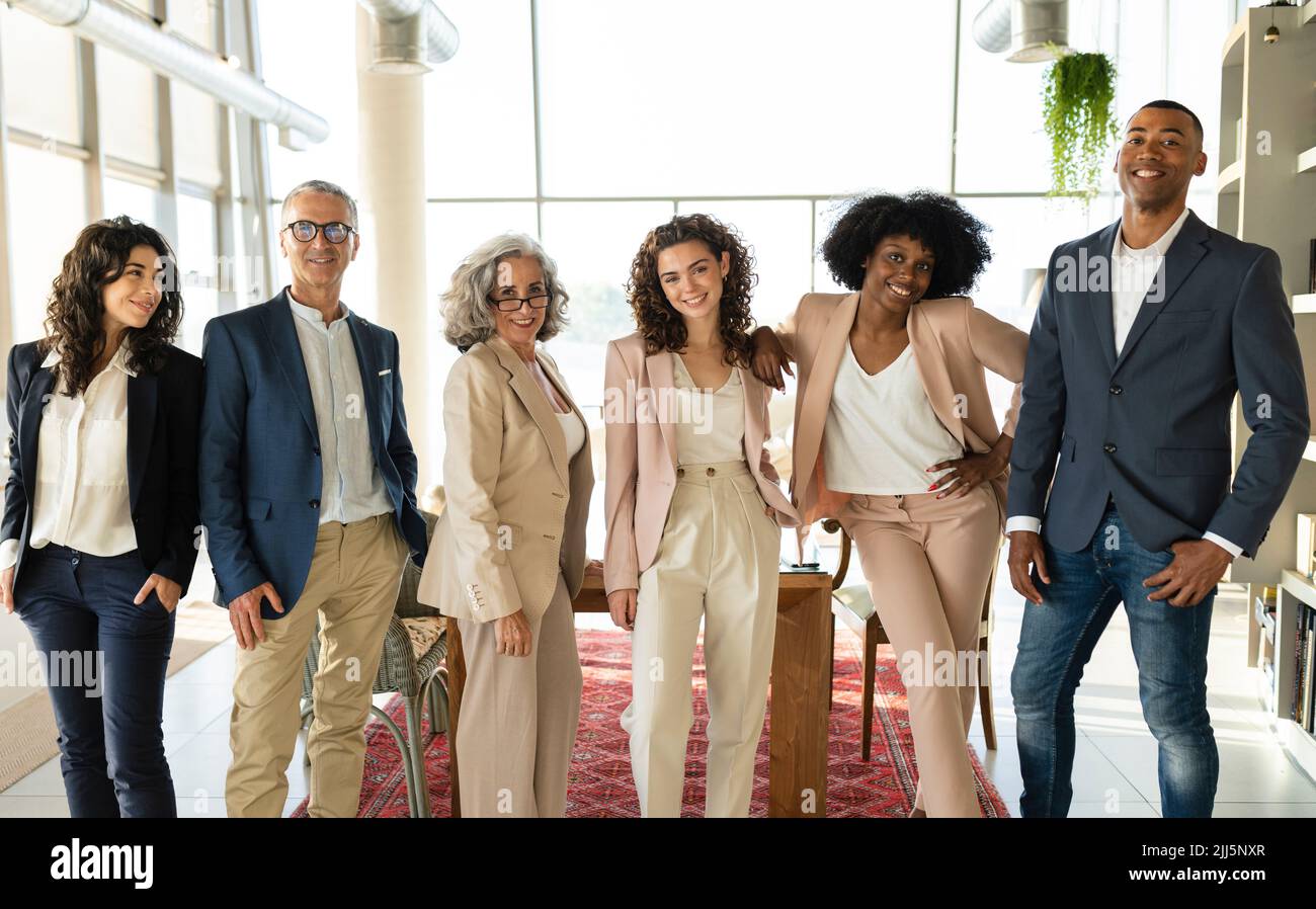 Smiling corporate business colleagues standing together at office Stock Photo