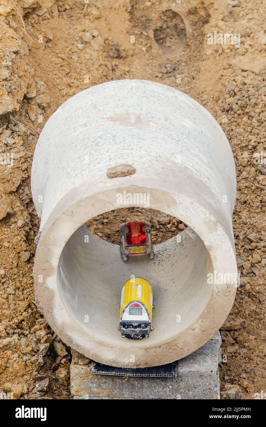 Pipe laser installed inside concrete pipe by site engineer to provide