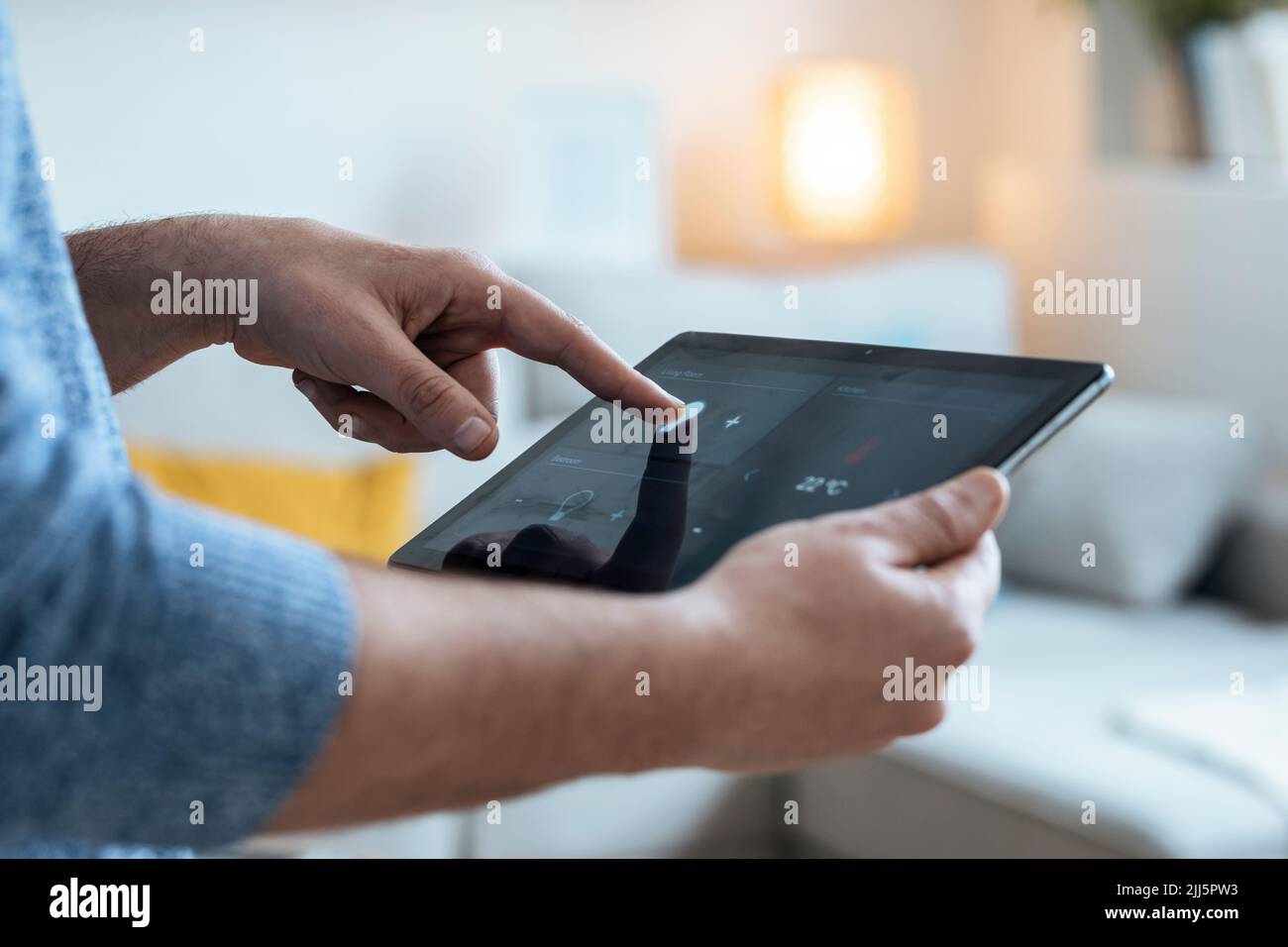 Hands of mature man using tablet PC in smart home Stock Photo