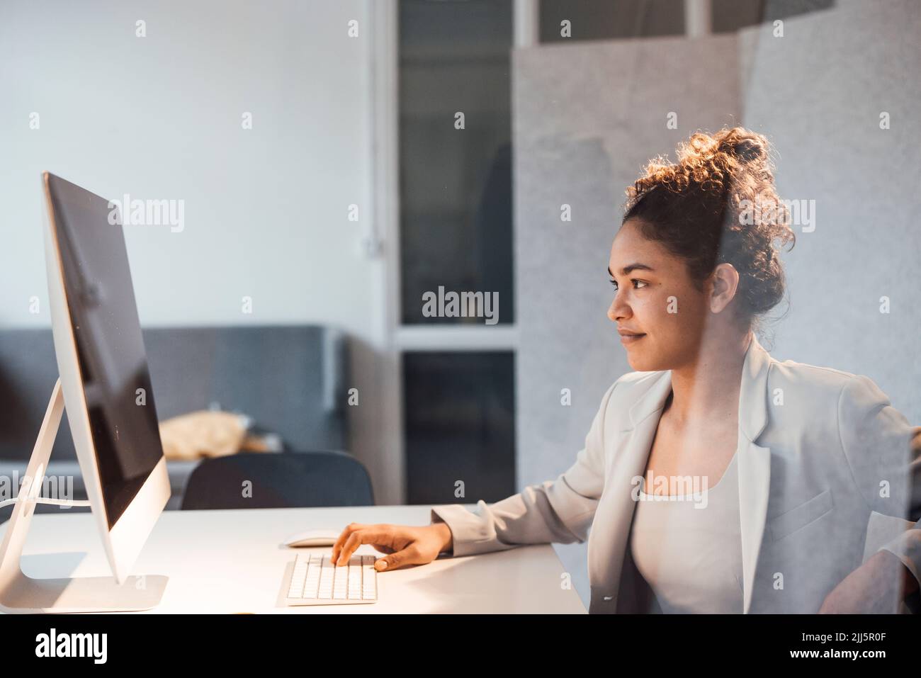 Young businesswoman working on computer in office Stock Photo