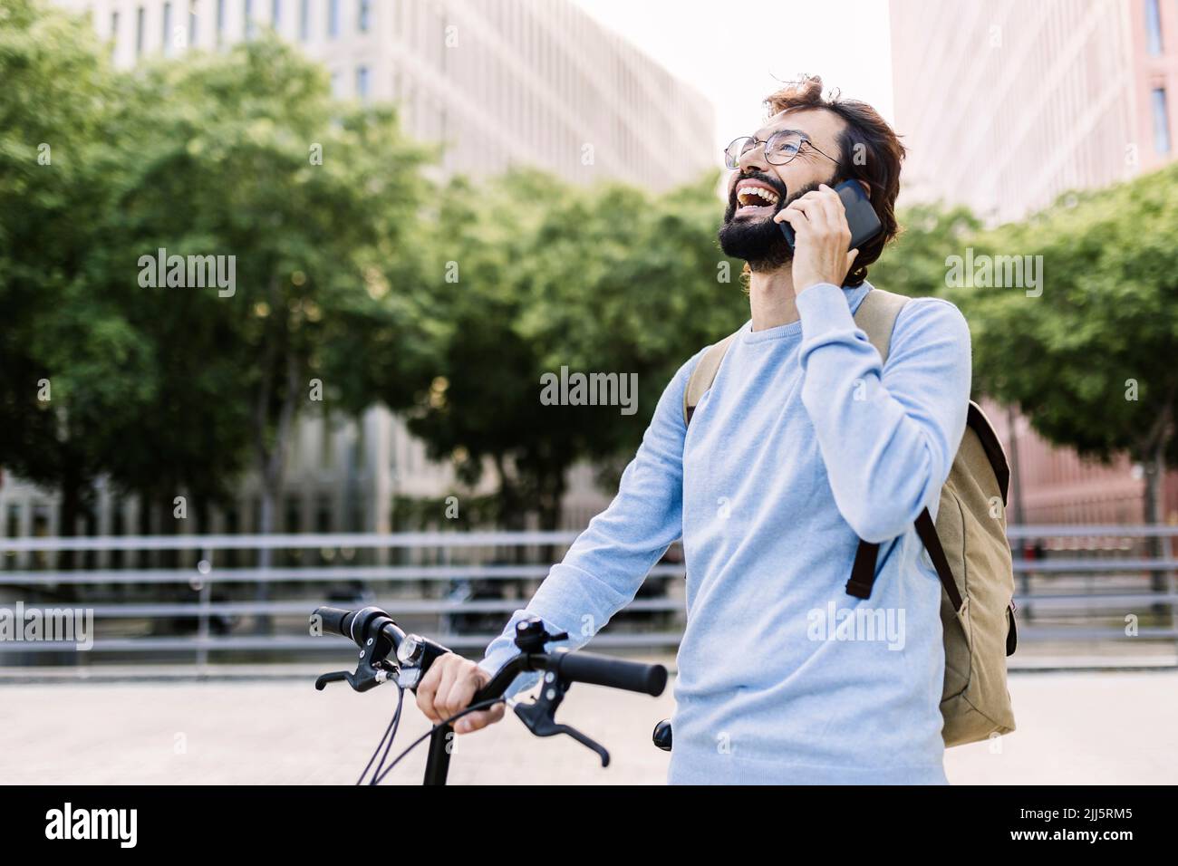 Happy bearded man talking on mobile phone Stock Photo