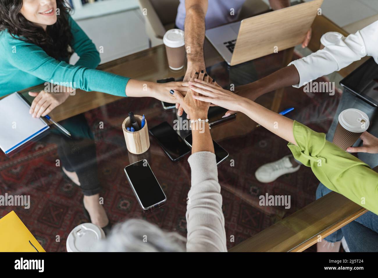 Business colleagues stacking hands together in office Stock Photo Alamy