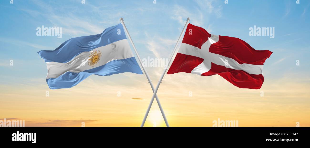 crossed national flags of Argentine and denmark flag waving in wind at ...