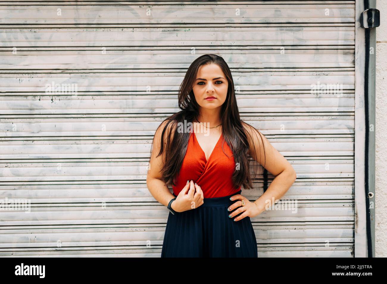Confident woman standing arms akimbo hi-res stock photography and ...
