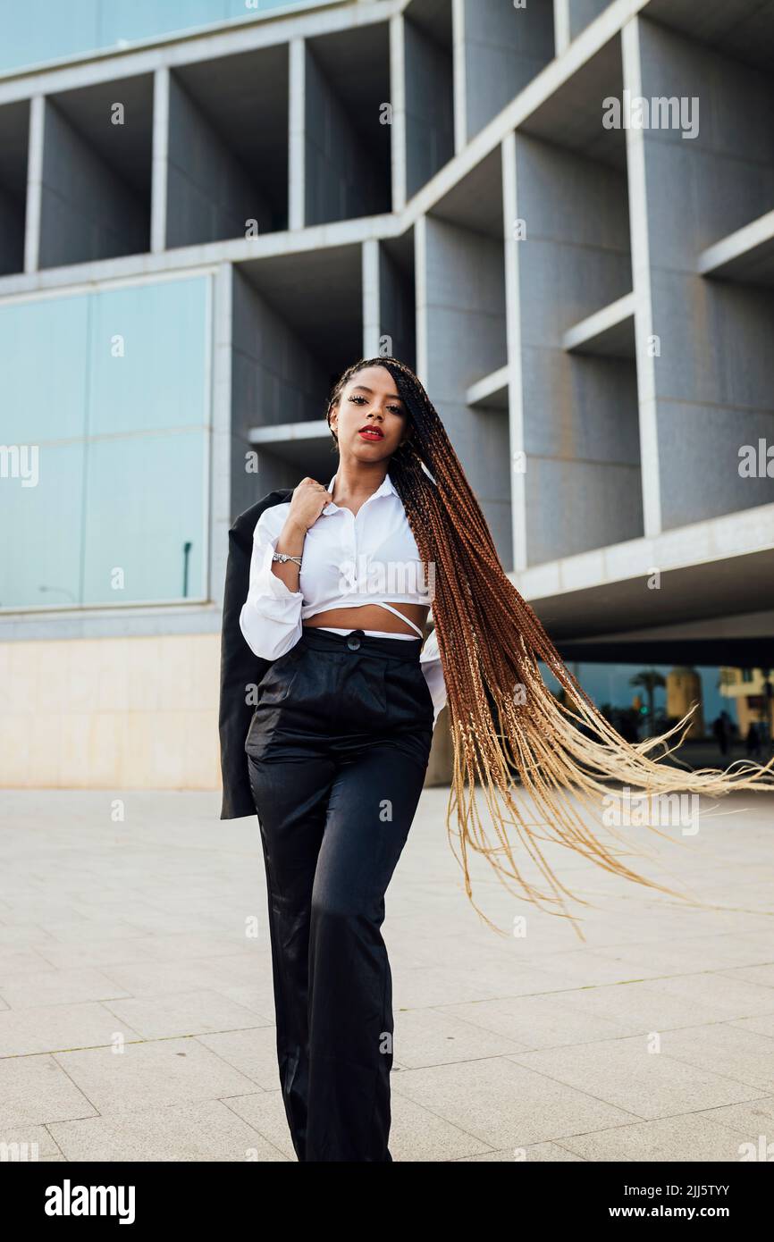 Confident woman long braided hair hi-res stock photography and images ...