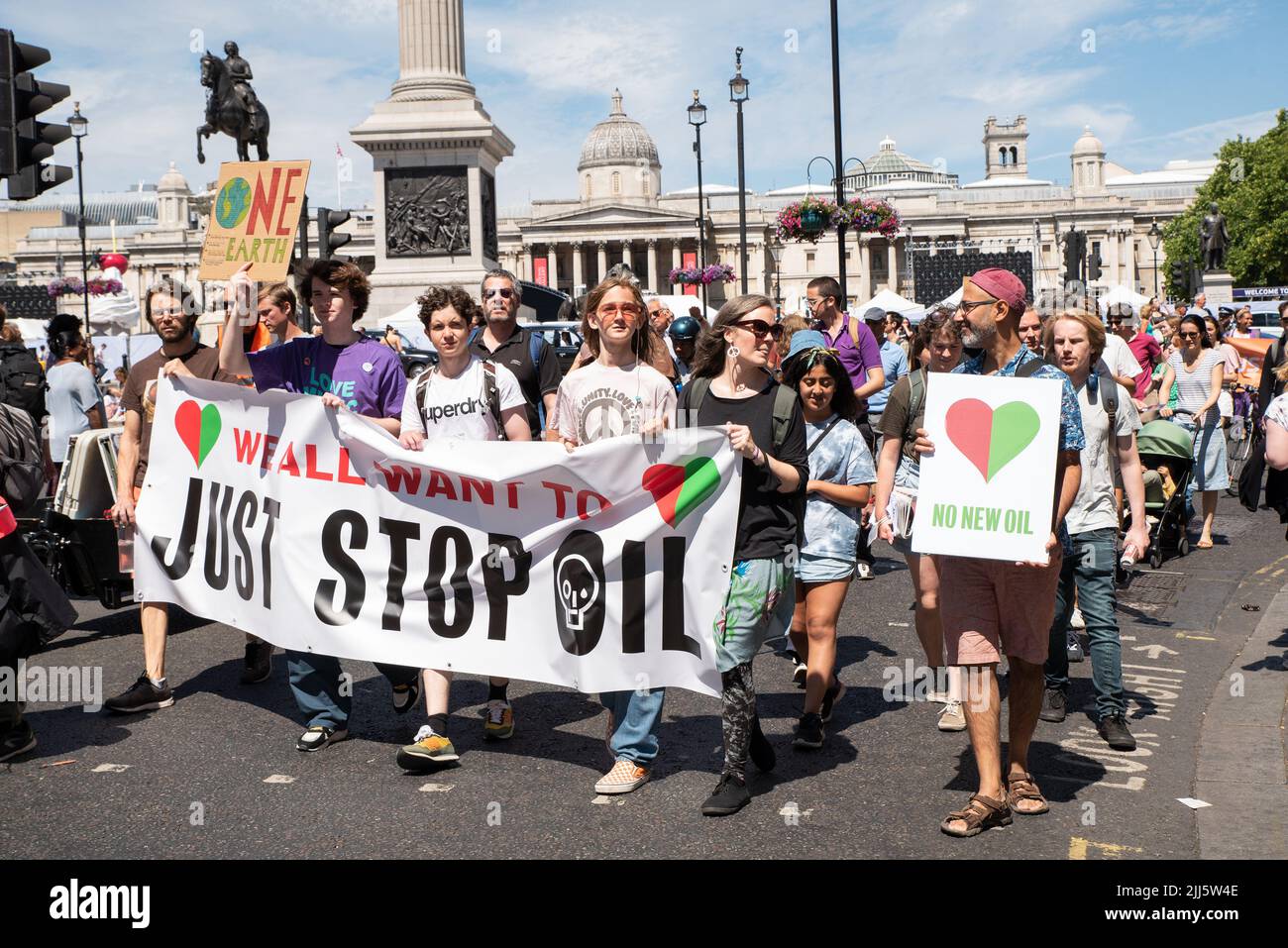 London, UK. 23rd July 2022. We All Want To Just Stop Oil Coalition: National March & Sit Down. One of many marches converging upon Westminster. March passing Trafalgar Square.  Credit: Stephen Bell/Alamy Live News Stock Photo