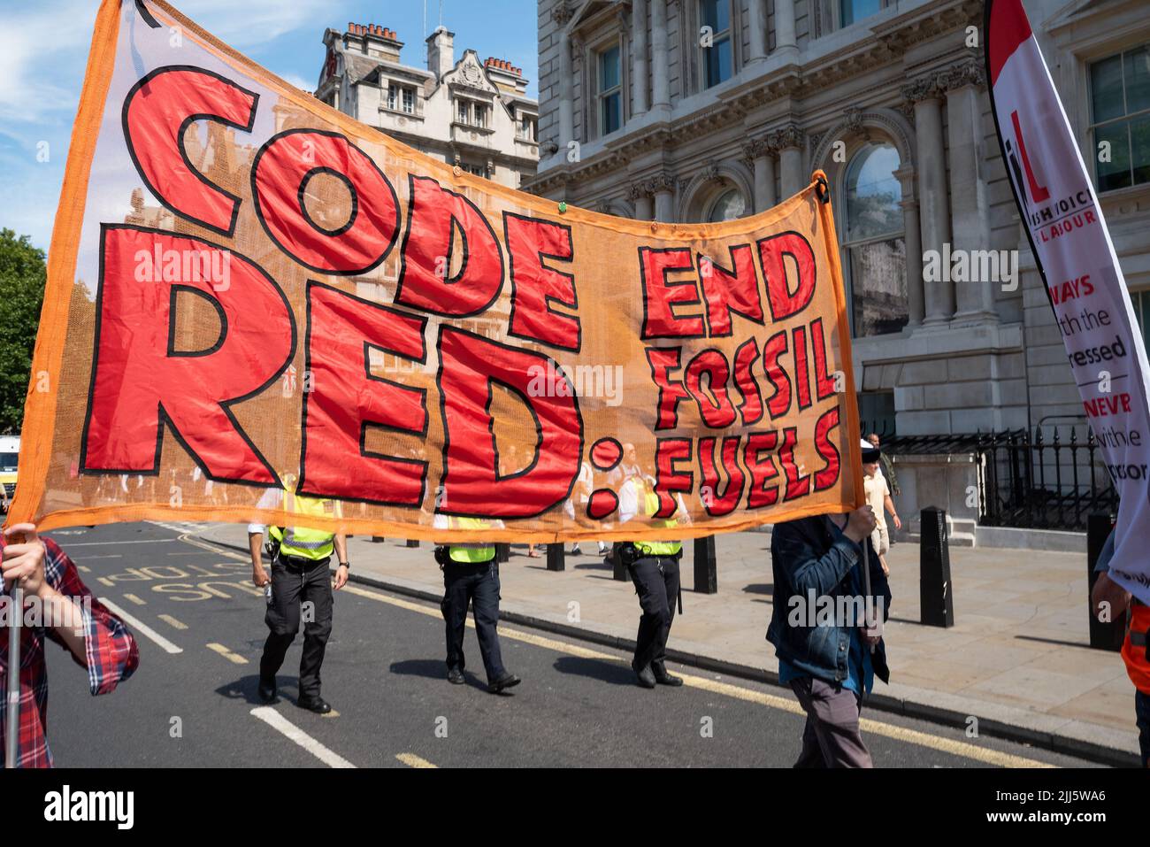 London, UK. 23rd July 2022. We All Want To Just Stop Oil Coalition: National March & Sit Down. One of many marches converging upon Westminster. Marchers with large Code Red End Fossil Fuels banner. Credit: Stephen Bell/Alamy Live News Stock Photo