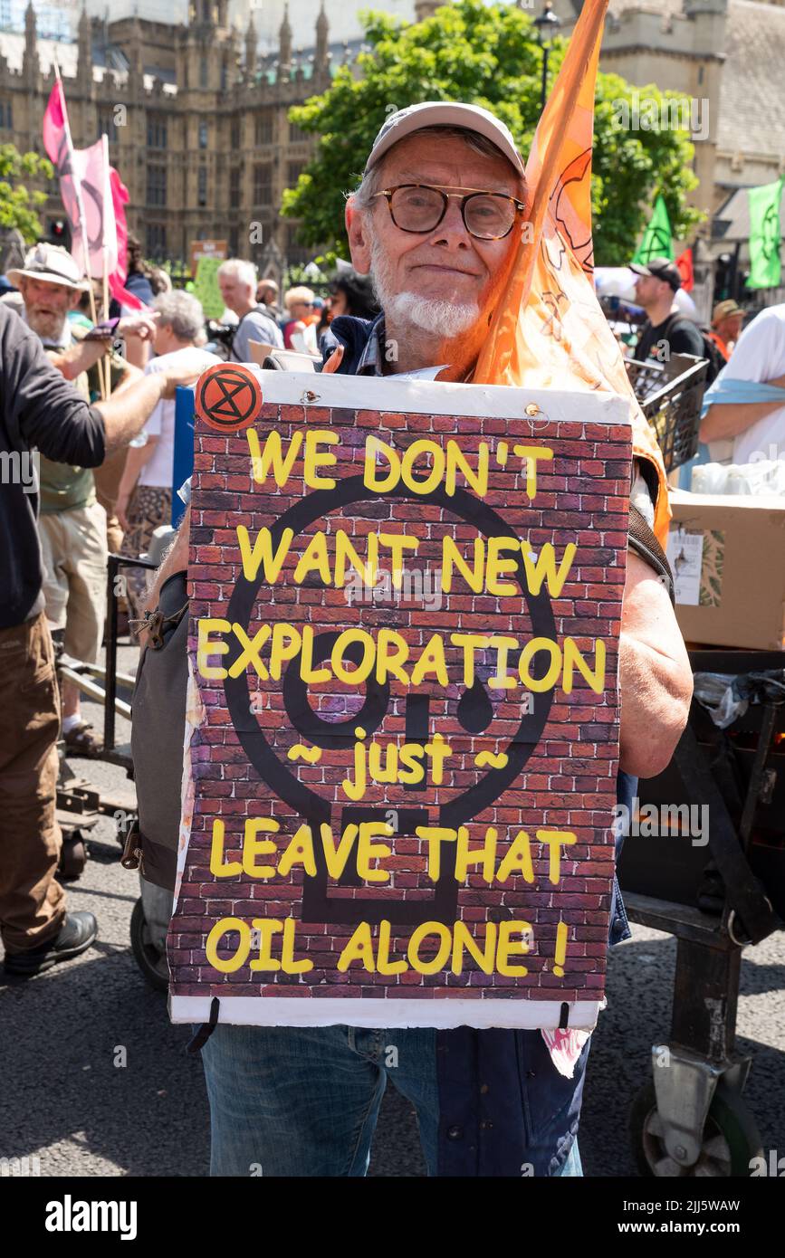 London, UK. 23rd July 2022. We All Want To Just Stop Oil Coalition: National March & Sit Down. One of many marches that converged upon Westminster. Protester holding We Don't Want New Exploration just Leave That Oil Alone placard. Credit: Stephen Bell/Alamy Live News Stock Photo