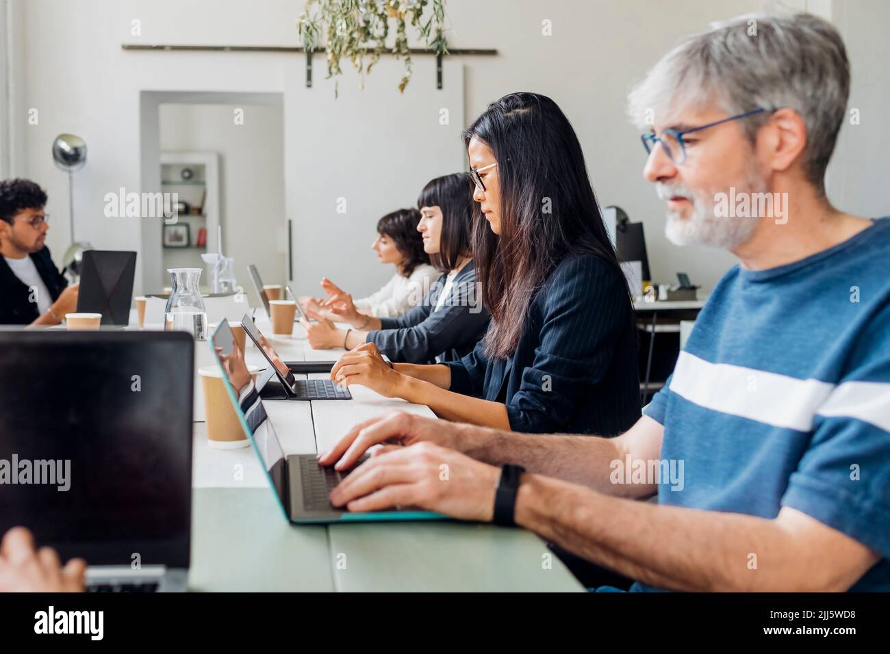 Multiracial business team using laptops hi-res stock photography and ...