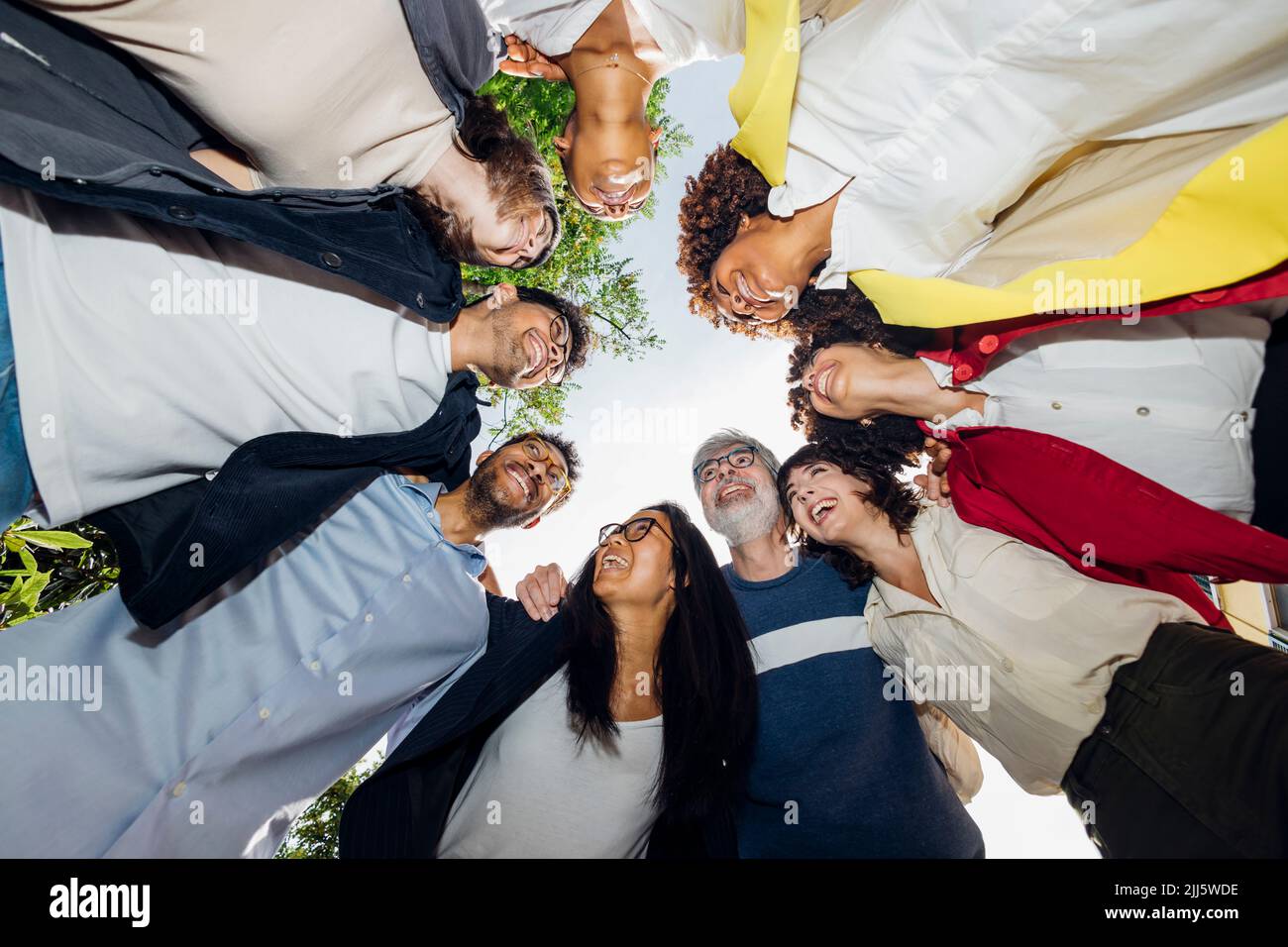 Happy multiracial business people huddling together Stock Photo