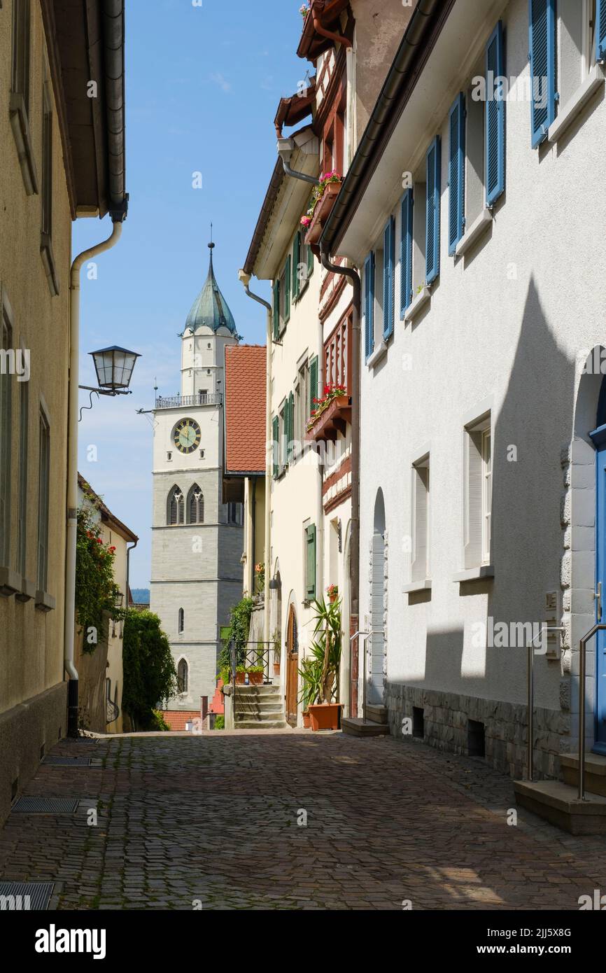 Germany, Baden-Wurttemberg, Uberlingen, Cobblestone alley with bell tower of Sankt Nikolaus church in background Stock Photo
