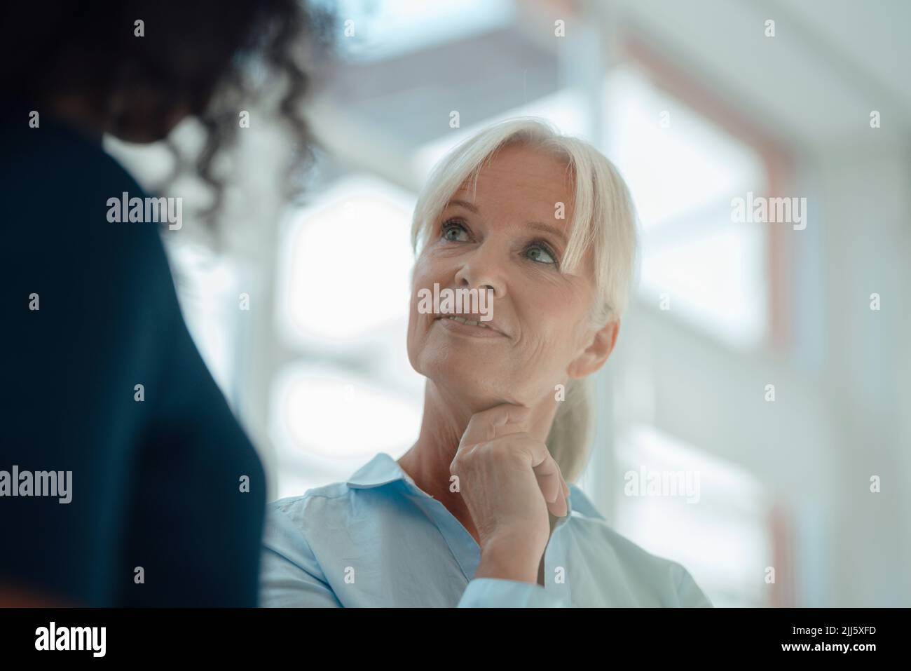 Businesswoman with colleague in office Stock Photo