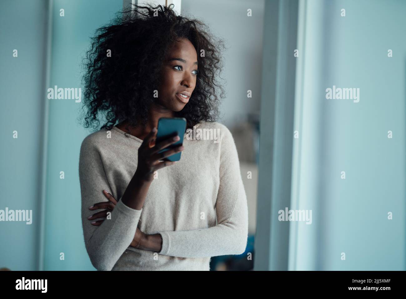 Young woman holding smart phone Stock Photo