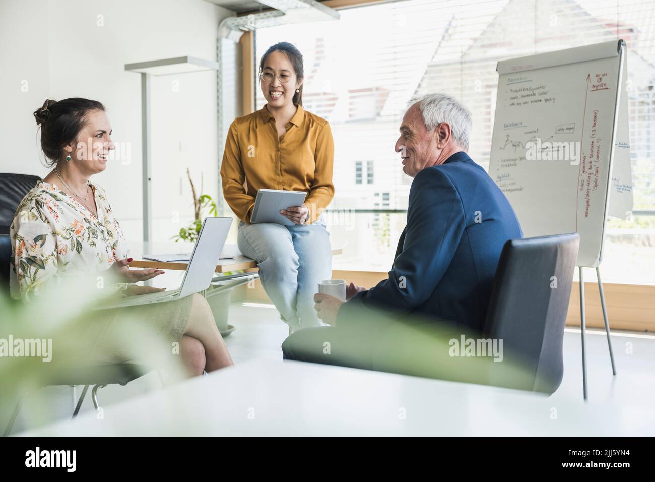 Happy business colleagues having meeting at work place Stock Photo