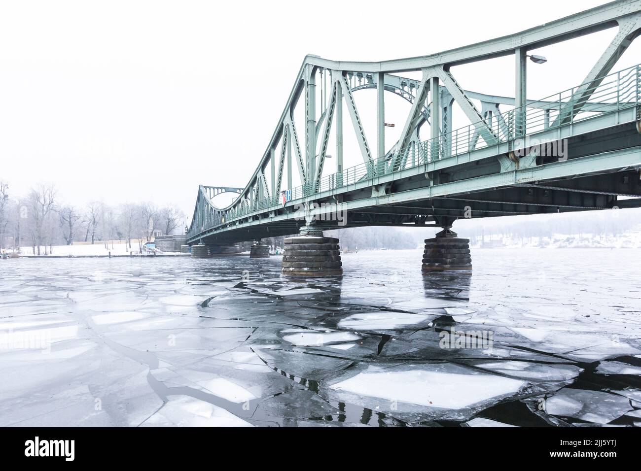 Germany, Brandenburg, Potsdam, Ice floating in river Havel with Glienicke Bridge in background Stock Photo
