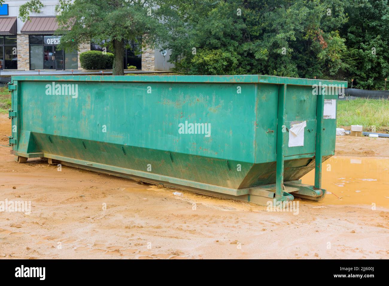 Using a metal container trash dumpster for recycling garbage is