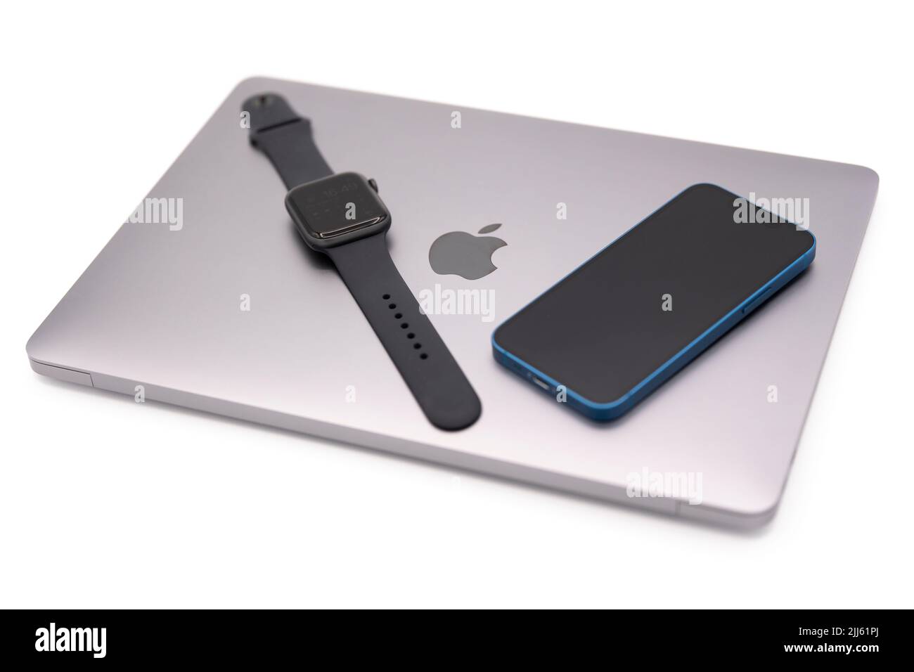 Apple products - MacBook Air laptop computer, Apple Watch smartwatch and Apple iPhone 13 Mini Stock Photo