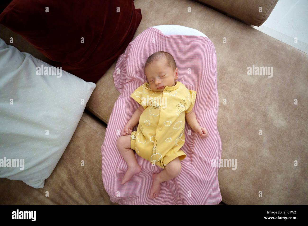 Overhead view of a baby sleeping on a sofa Stock Photo
