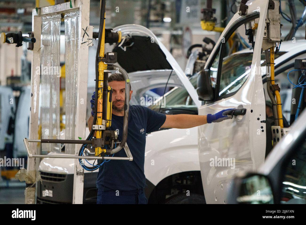 Worker at car factory assembly line Stock Photo
