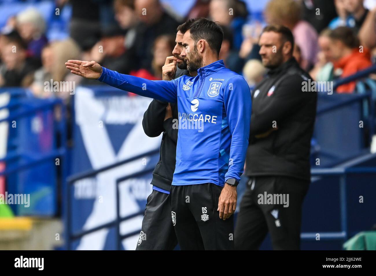 Danny Schofield manager of Huddersfield Town talks to his assistant during the game Stock Photo