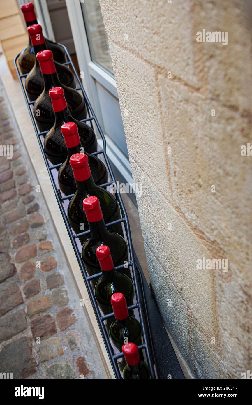 Set of red wine bottles in front of a winery Stock Photo