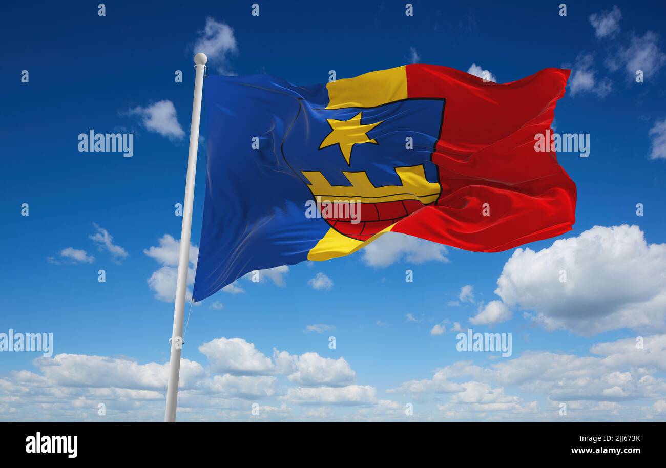 official flag of Guntersdorf Austria at cloudy sky background on sunset, panoramic view. Austrian travel and patriot concept. copy space for wide bann Stock Photo