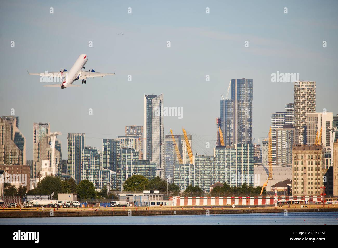 London Royal Albert Dock in Docklands area looking towards the business skyline of Canary Wharf Stock Photo