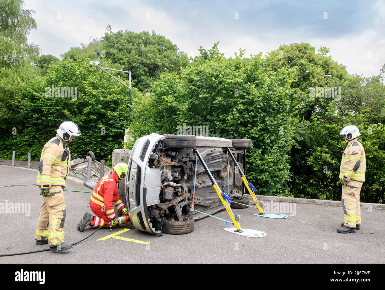 Firefighters use specialist equipment to move a car containing sensors away from an obstruction at Cardiff Gate Training Centre - data gathered will c Stock Photo
