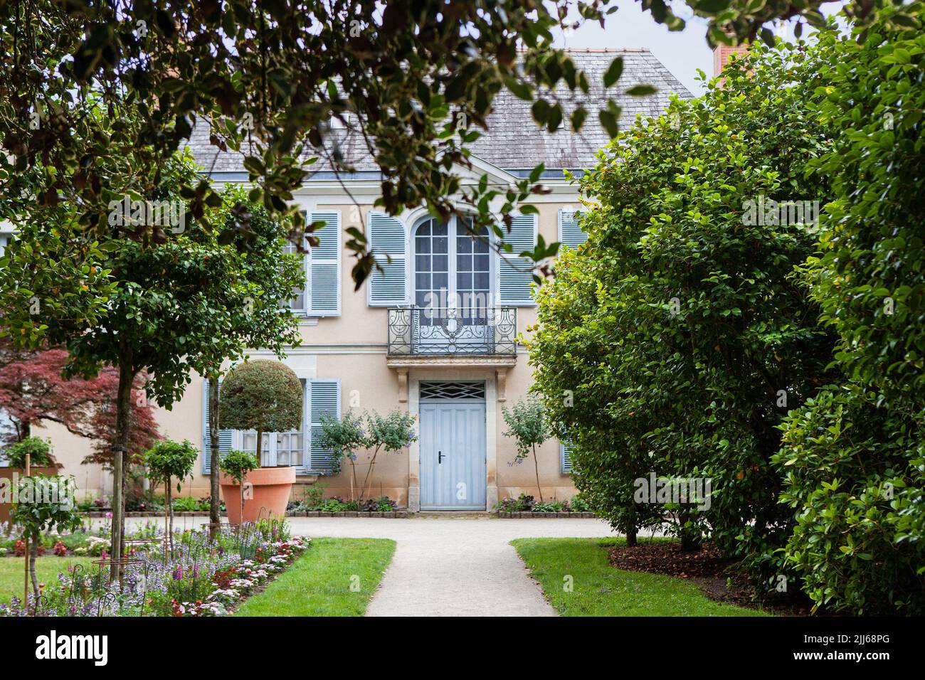 Public French house in a luxuriant park Stock Photo