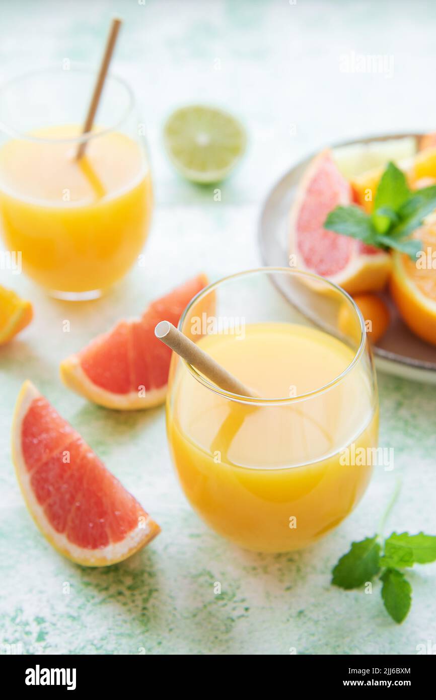 Glass of juice and fresh citrus fruits Stock Photo Alamy