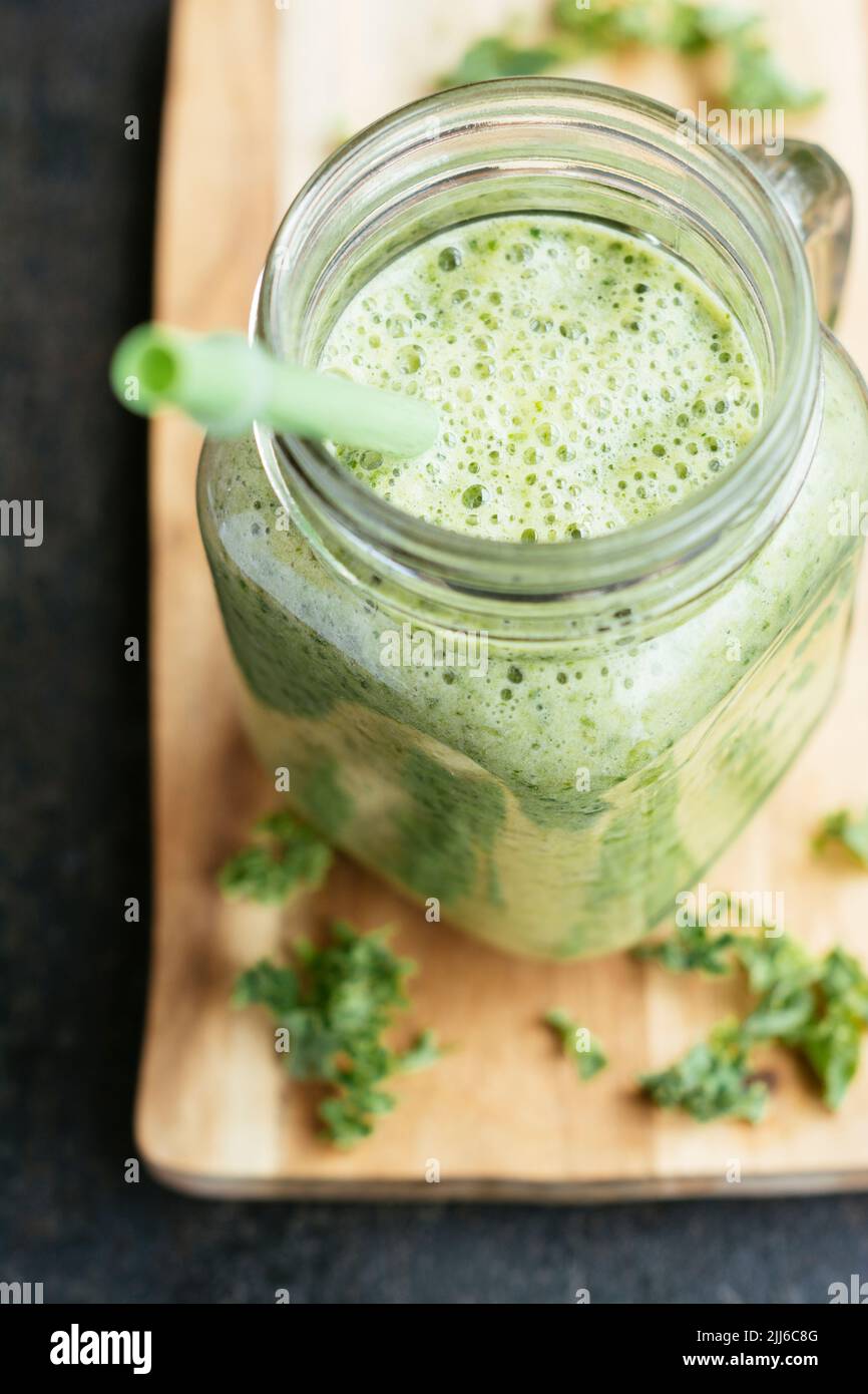 Healthy vegan kale smoothie with pineapple and banana. Stock Photo