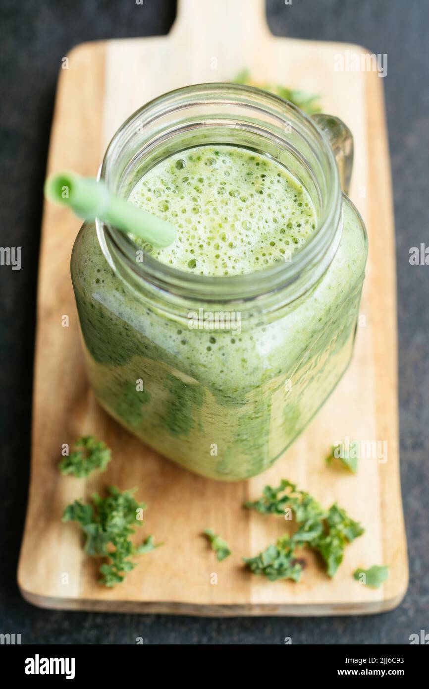 Healthy vegan kale smoothie with pineapple and banana. Stock Photo