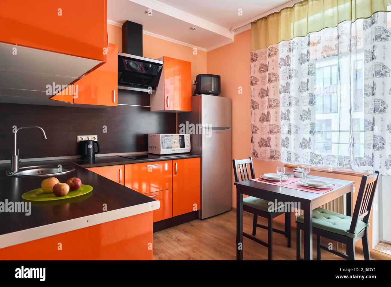 Photo of orange kitchen for daily rent Stock Photo